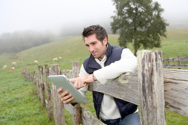Breeder using electronic tablet in field
