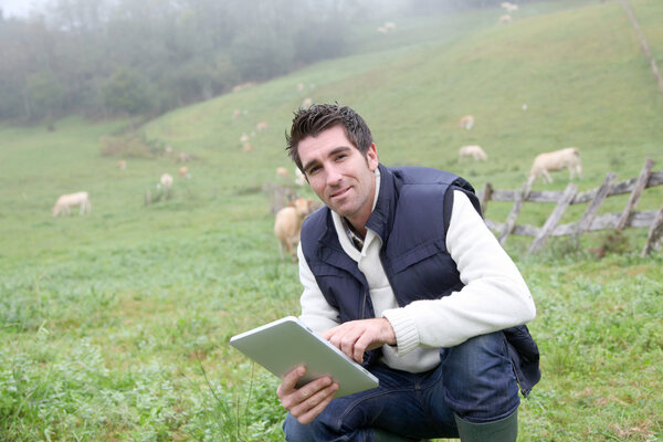Breeder using electronic tablet in field