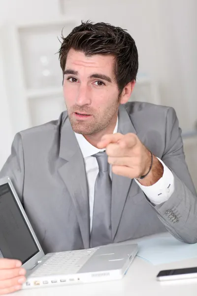 Businessman showing something on laptop computer — Stock Photo, Image