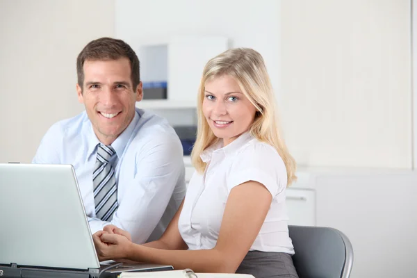 Man and woman working in the office on laptop computer Stock Image