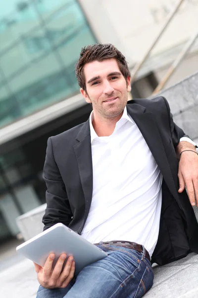 Man using electronic tablet in front of modern building Stock Image