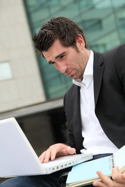 Salesman working outside building of offices Stock Photo