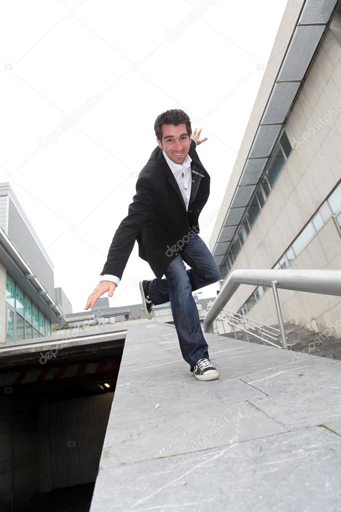 Man running downstairs with stretched arms