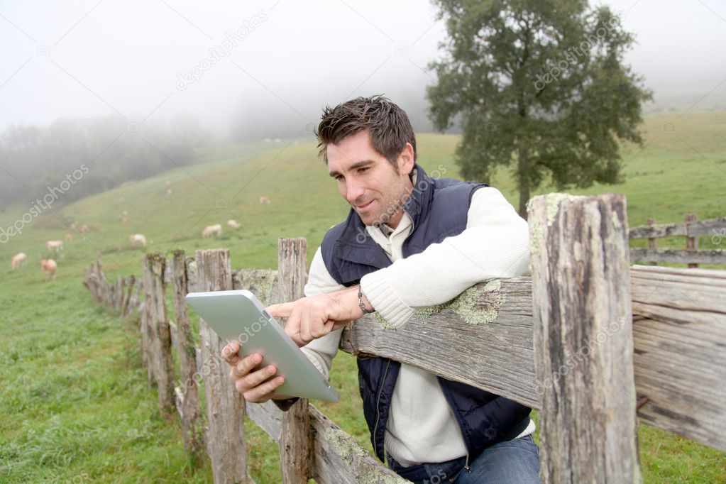Breeder using electronic tablet in field