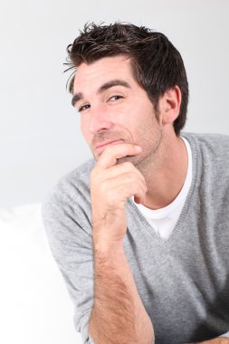 Portrait of handsome guy with hand on chin