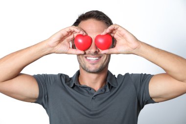 Man covering his eyes with 2 hearts clipart