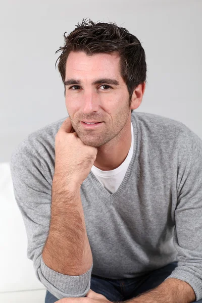 Portrait of handsome guy with hand on chin — Stock Photo, Image