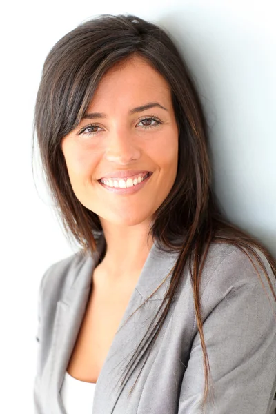 Beautiful businesswoman standing on grey background — Stock Photo, Image