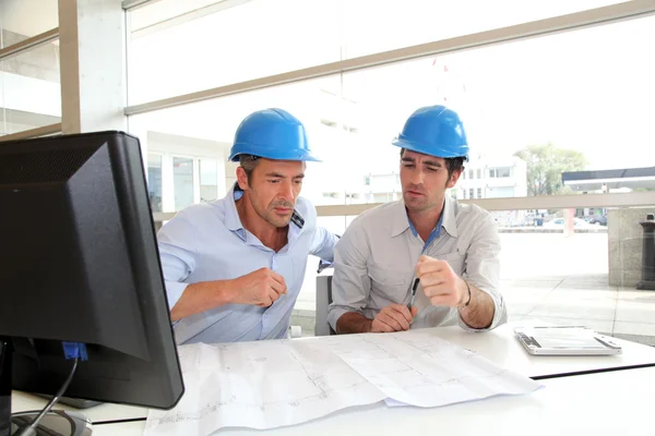 Architects working on construction plan — Stock Photo, Image