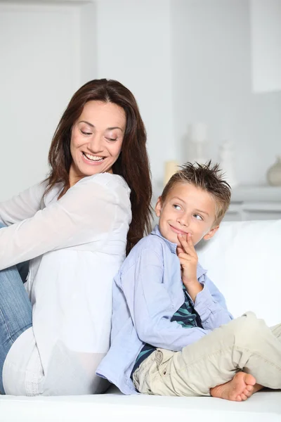 엄마와 함께 소파에 앉아 작은 금발 소년 — 스톡 사진