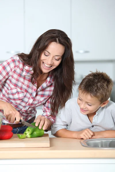 Mother cooking with son in kitchen — Stock Photo, Image