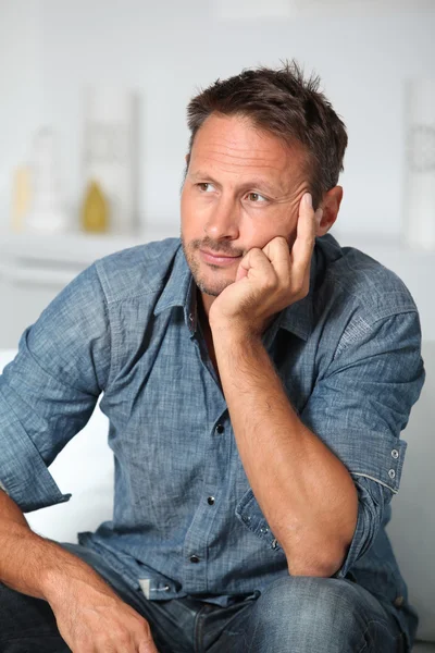 Closeup of man sitting in sofa — Stock Photo, Image