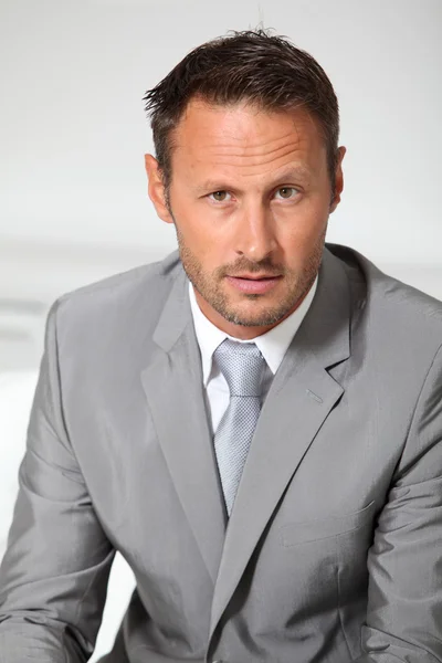 Closeup of businessman wearing grey suit — Stock Photo, Image