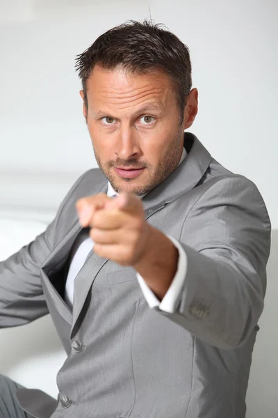 Businessman pointing finger at camera — Stock Photo, Image