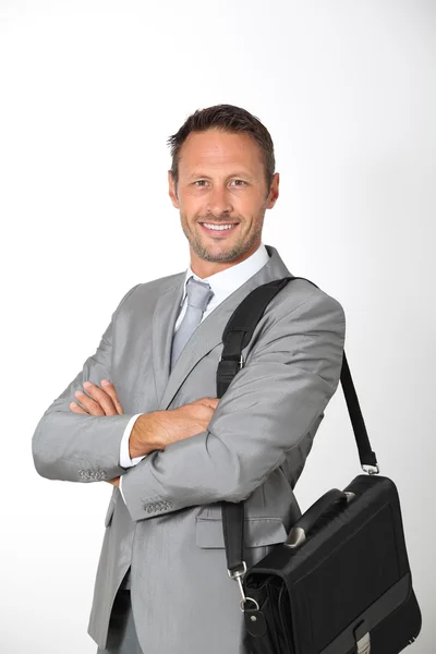 Businessman holding briefcase on shoulder — Stock Photo, Image