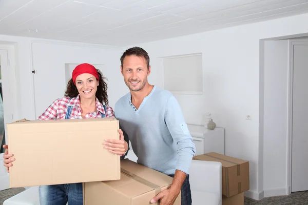 Casal segurando caixas em sua nova casa — Fotografia de Stock