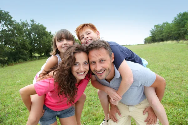 Ouders doen piggyback aan hun kinderen — Stockfoto