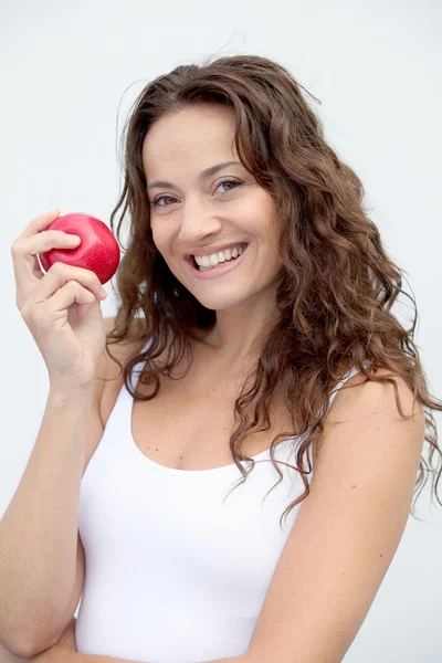 Closeup of woman eating a red apple — Stok fotoğraf