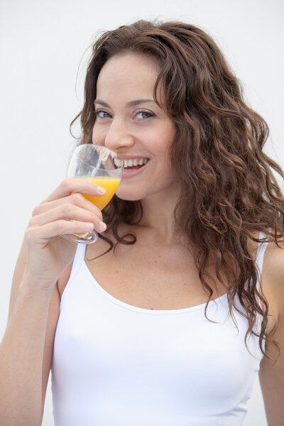 Closeup of beautiful woman drinking orange juice