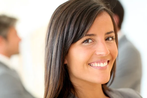 Portrait of beautiful businesswoman standing in front of group Stock Picture