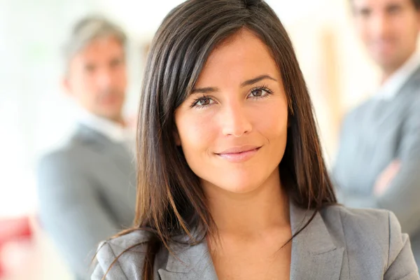 Portrait of beautiful businesswoman standing in front of group Royalty Free Stock Photos