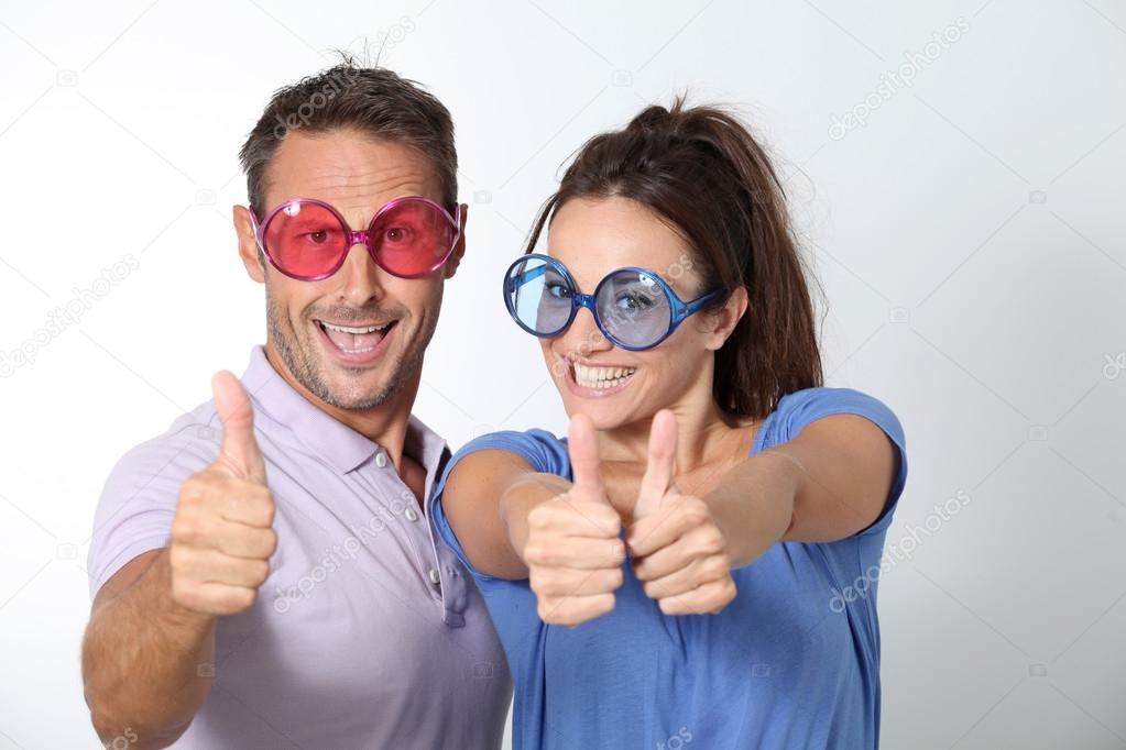 Couple wearing colored glasses having fun