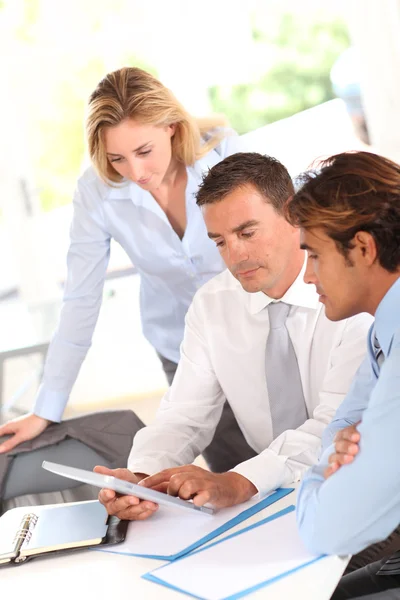 Business group around table with electronic tablet — Stock Photo, Image