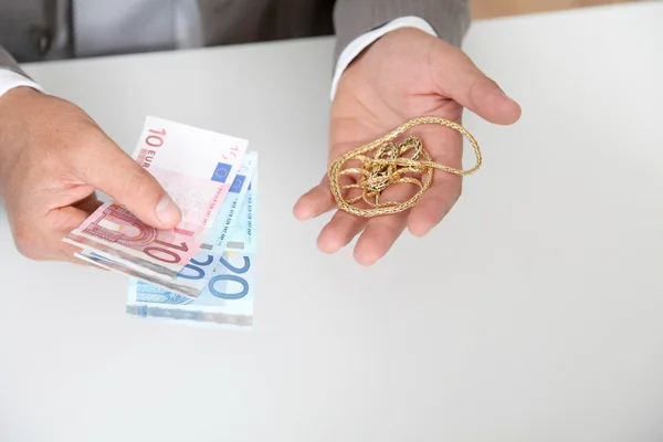 Gold against cash money — Stockfoto