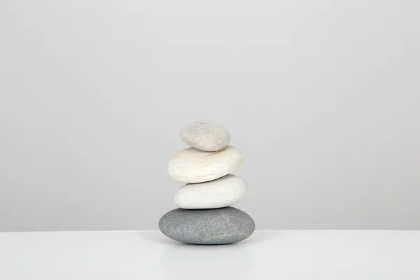 Pile of pebbles set on table — Stock Photo, Image