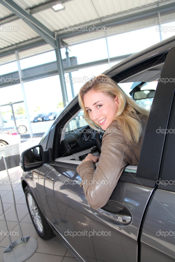 Woman sitting in brand new car