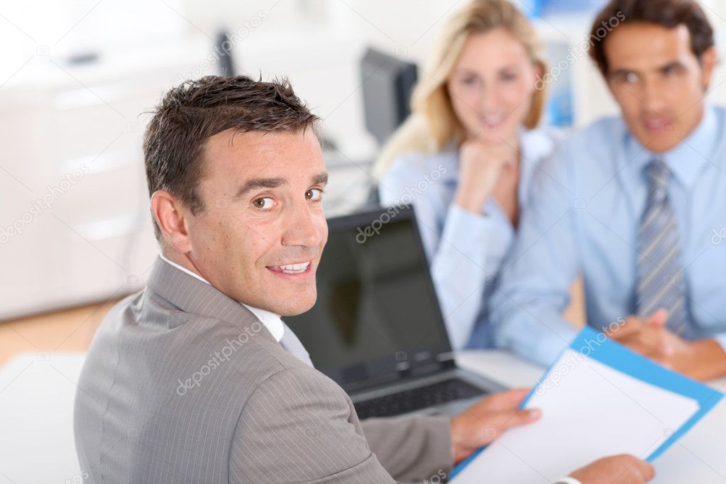 Couple with real-estate agent in office