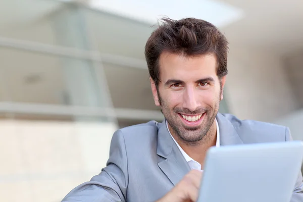 Portrét usmívajícího se muže používat elektronický tablet mimo — Stock fotografie