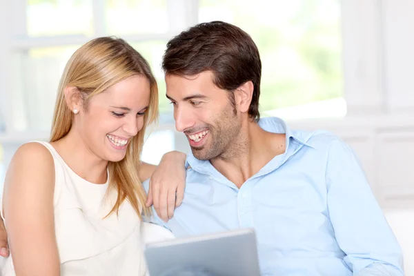 Young couple using electronic tablet at home — Stock Photo, Image
