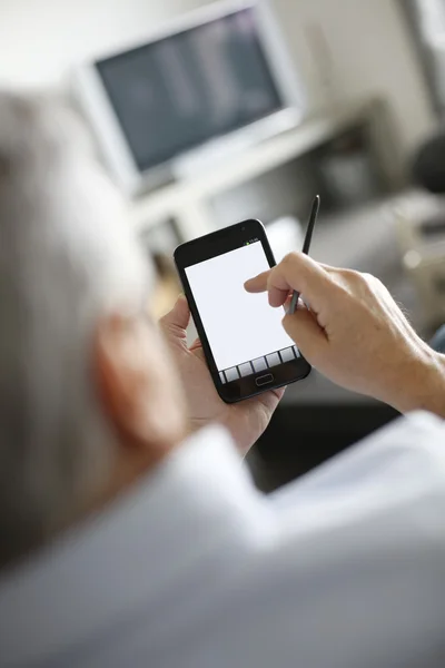 Back view of senior man using smartphone — Stock Photo, Image