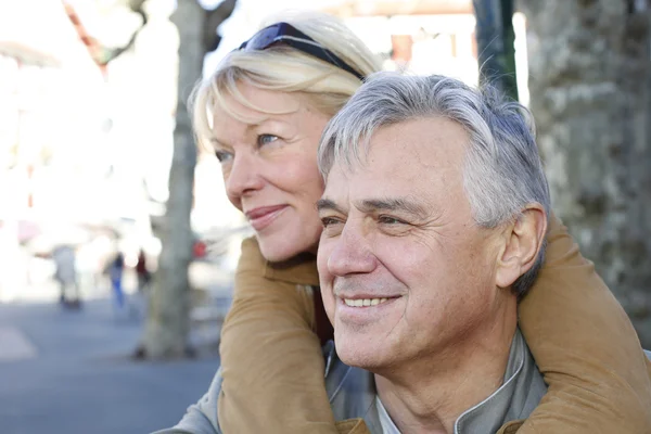 Portrait of senior man holding woman on his back — Stock Photo, Image