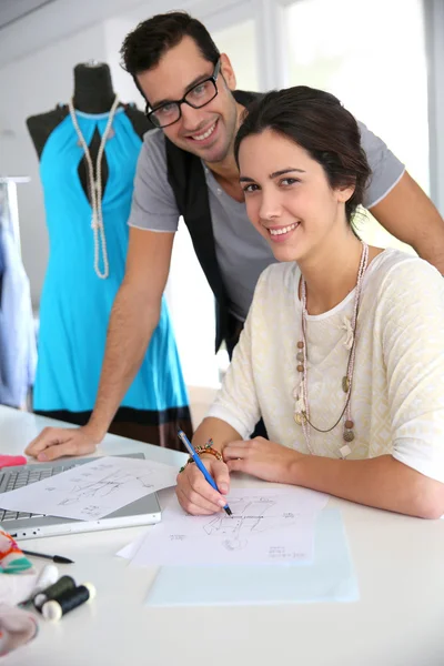 Fashion designers working on creation in workshop — Stock Photo, Image