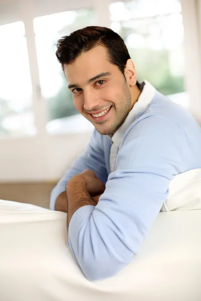 Young man sitting in sofa — Stock Photo, Image