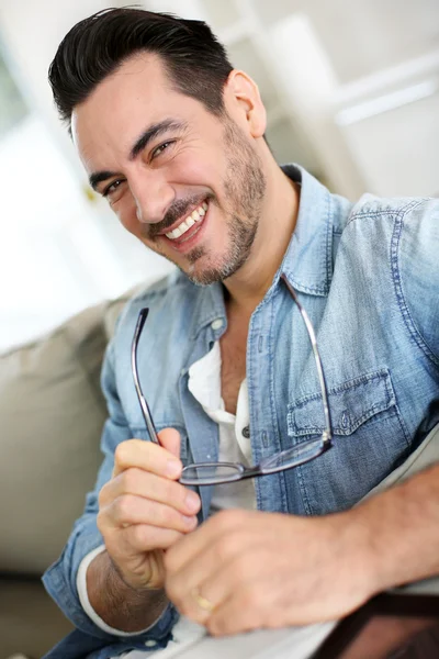 Funny mature man holding eyeglasses — Stock Photo, Image