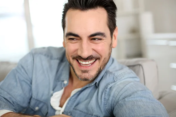 Handsome middle-aged man relaxing in sofa — Stock Photo, Image