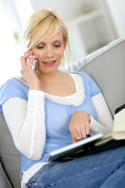 Woman on the phone checking agenda — Stock Photo, Image