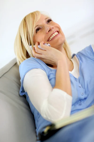 Beautiful blond woman laughing on the phone — Stock Photo, Image