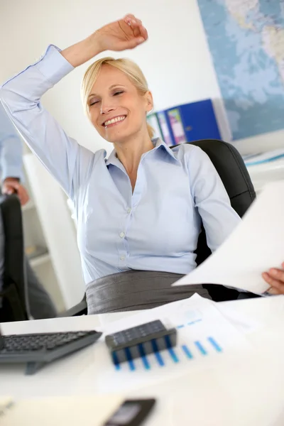 Glada affärskvinna avkopplande i office — Stockfoto