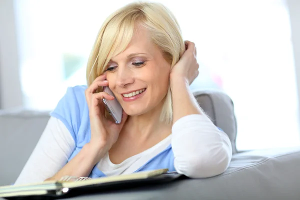 Woman on the phone checking agenda Royalty Free Stock Images