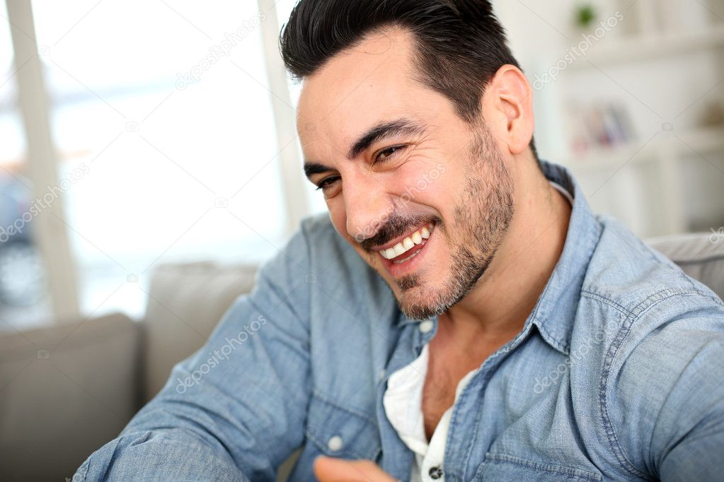 Handsome middle-aged man relaxing in sofa