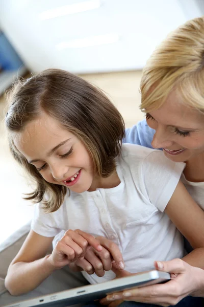 Madre e figlia giocare con tablet elettronico — Foto Stock