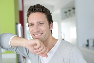 Portrait of handsome single man at home clipart