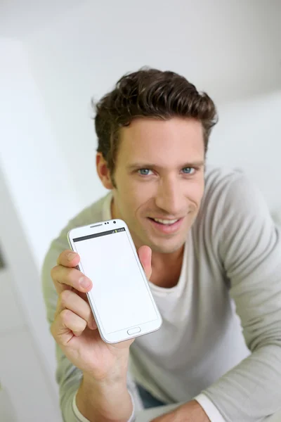 Man showing smartphone to camera — Stock Photo, Image