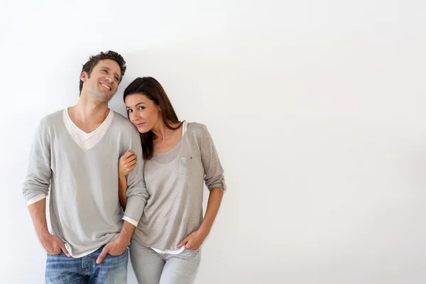 Young couple standing on white background — Stock Photo, Image