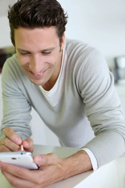 Man taking note on smartphone Stock Photo