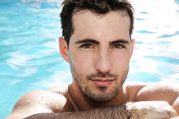 Portrait of handsome guy in swimming-pool — Stock Photo, Image